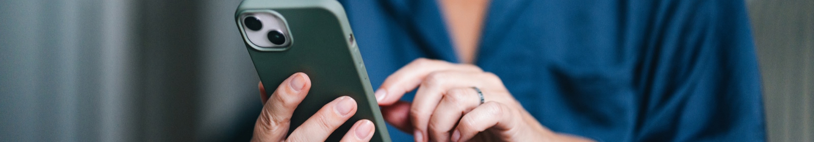 close-up of hands using a smartphone