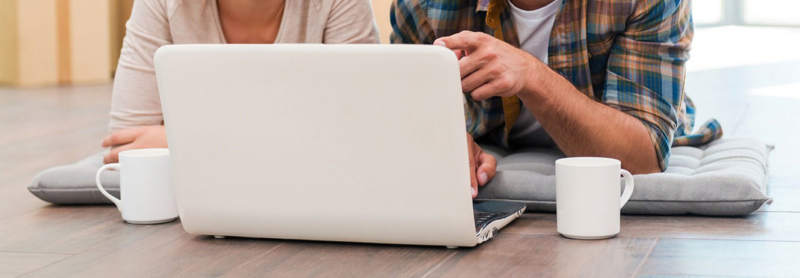 Man and woman on computer together in home. 